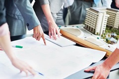 Architect team discussing about blueprint