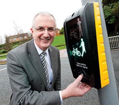 Minister for Regional Development, Danny Kennedy using the new pedestrian and cycle toucan puffin crossing at East Link Road, Dundonald.