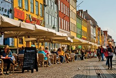 Photo of restaurant patios along Nyhavn in Copenhagen, Denmark.