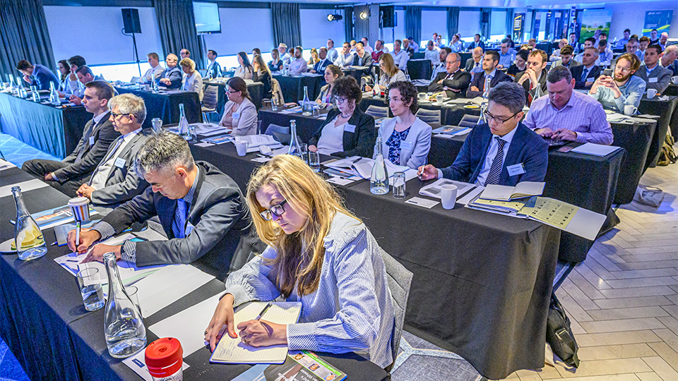 Delegates taking notes at a conference