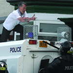 A man gestures at police during trouble on the Woodvale Road on 12 July.